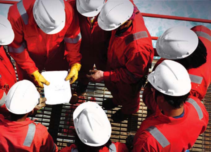 Technical partners collaborating on industrial equipment